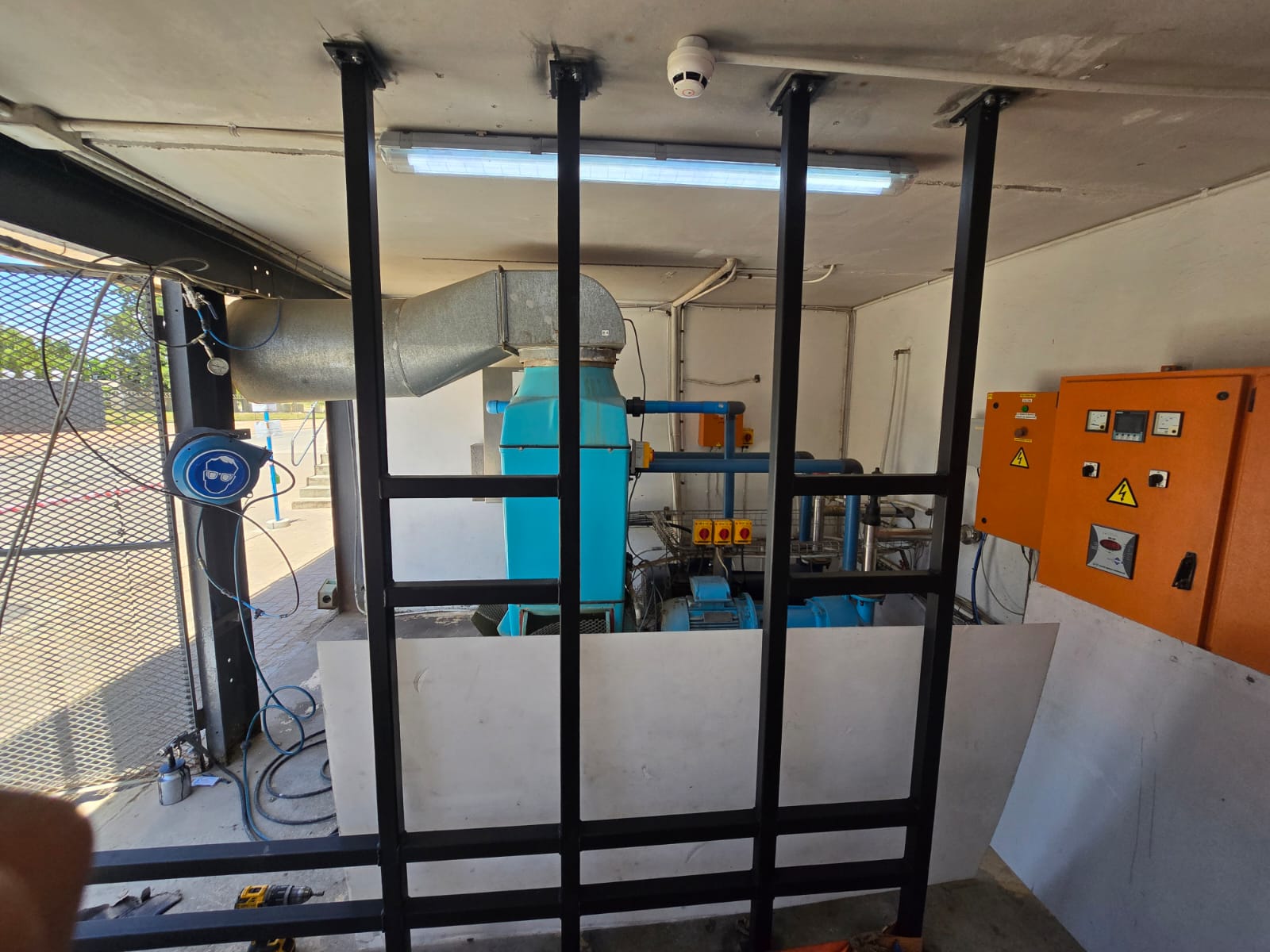 Newly constructed steel-framed industrial enclosure with pump and ventilation equipment installation